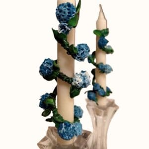 A candle with blue flowers on it
