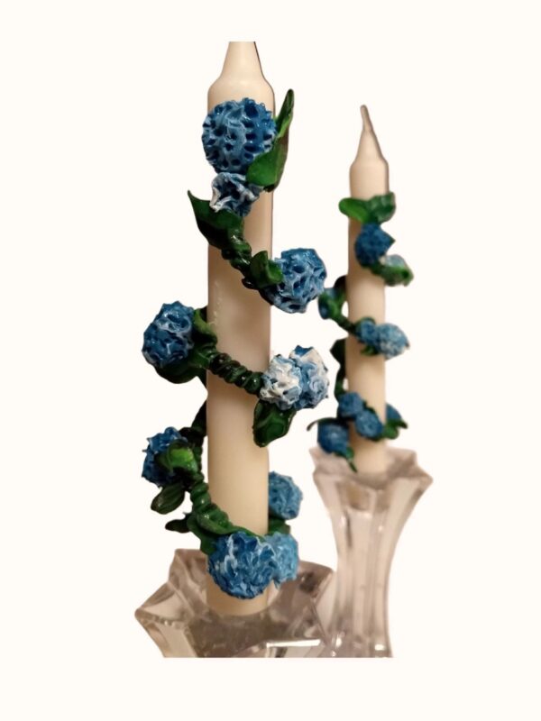 A candle with blue flowers on it