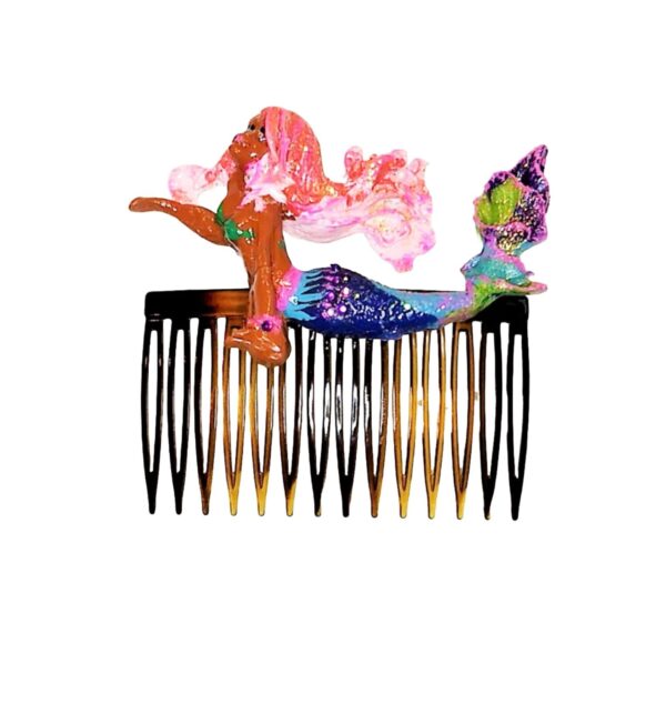 A comb with different colored hair and flowers.