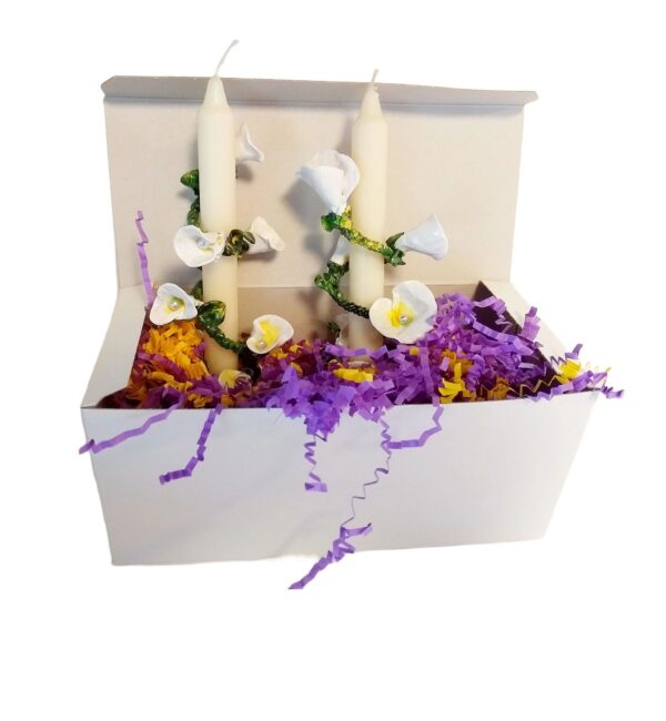 A box with flowers and candles inside of it