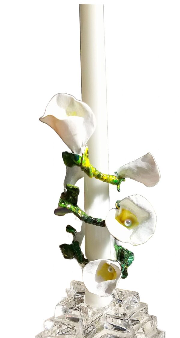 A white candle with flowers on it