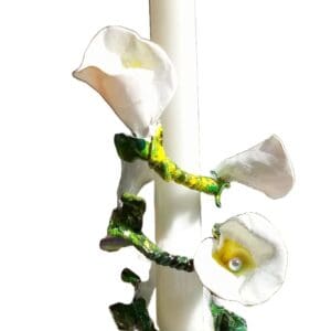 A white candle with flowers on it