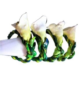 A group of four flowers that are sitting on top of a table.