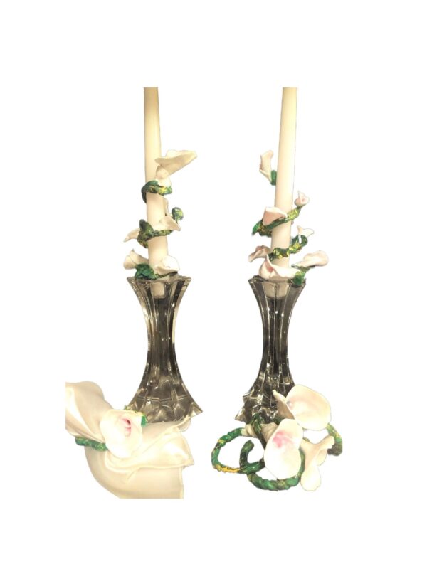 A pair of candles with flowers on them