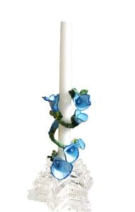 A candle with blue flowers on it