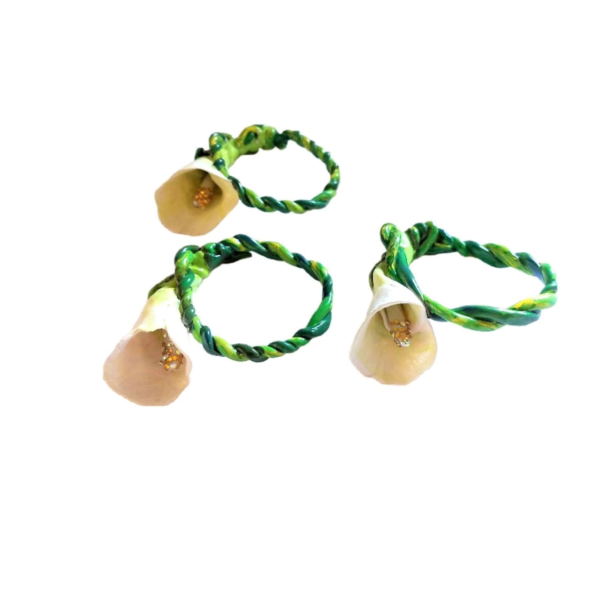 A group of three green bracelets with wooden beads.