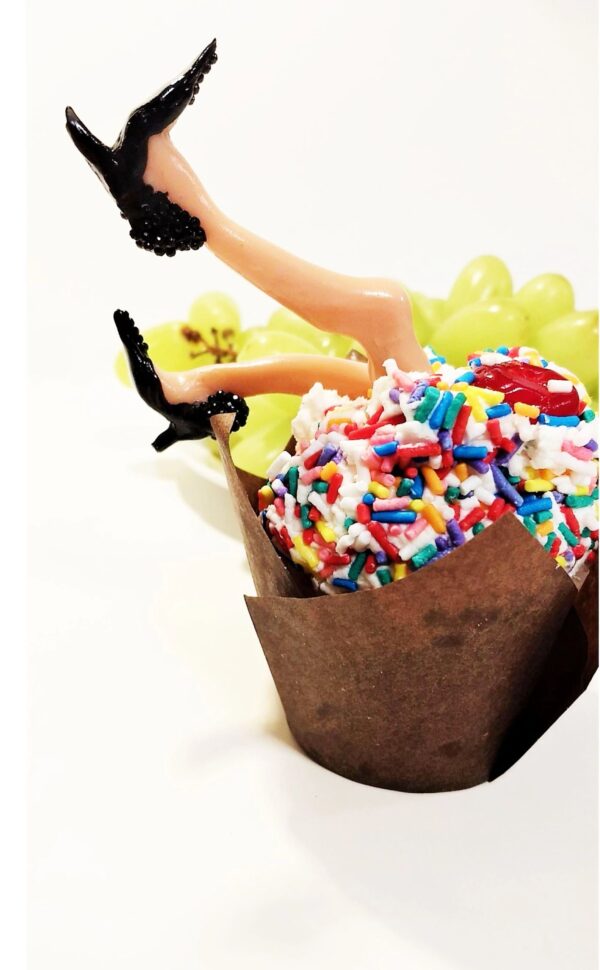 A person in high heels sitting on top of a box.