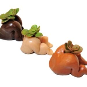 Three different colored vegetables are sitting in a row.