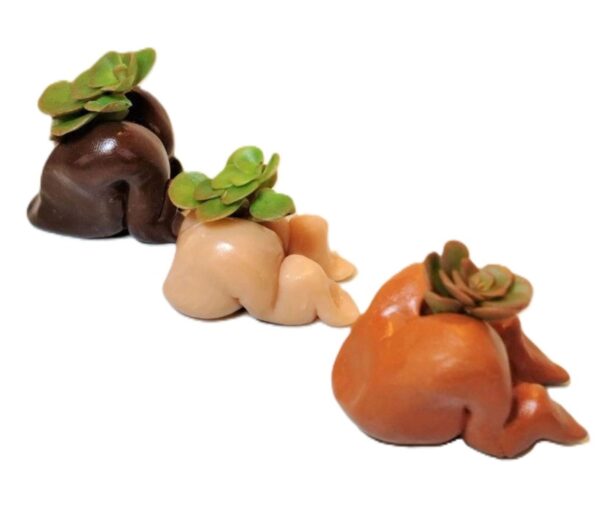 Three different colored vegetables are sitting in a row.