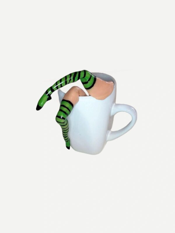 A cup with two legs sticking out of it