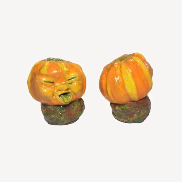 Two pumpkins are sitting on a piece of wood.