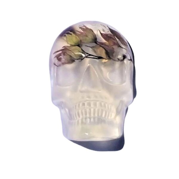 A skull with flowers on it's forehead.