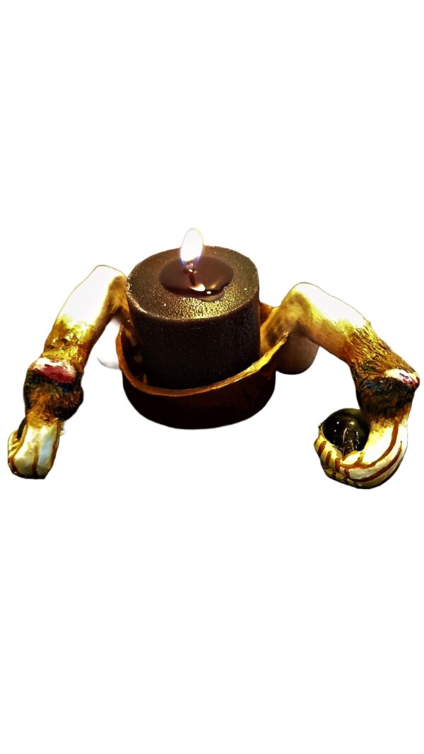 A candle is lit on top of the ground.