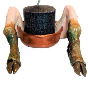 A close up of a candle holder with arms and legs