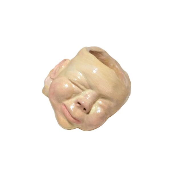 A ceramic head is shown with no hair.