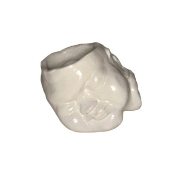 A white ceramic cup with a face on it.