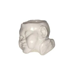 A white ceramic sculpture of a face.