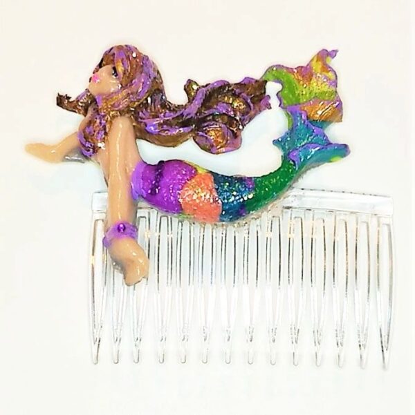 A hair comb with a mermaid and a purple haired doll.