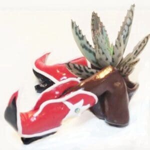 A pair of shoes with a plant in it