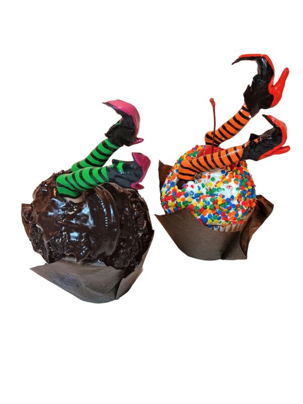 A pair of chocolate covered apples with candy toppings.