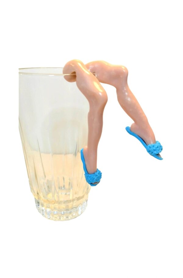 A glass of water with two blue shoes on it