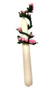 A candle with pink roses on it