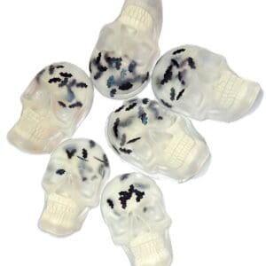 Clear skull-shaped resin pieces with inclusions.